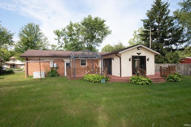 back of house with a yard and a deck