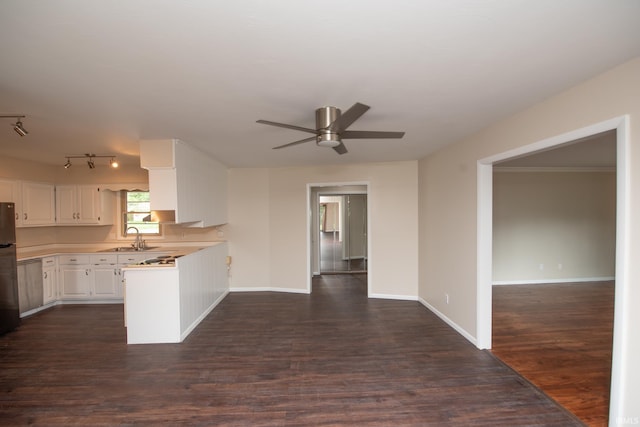 kitchen featuring dark wood-type flooring, sink, fridge, ceiling fan, and white cabinets