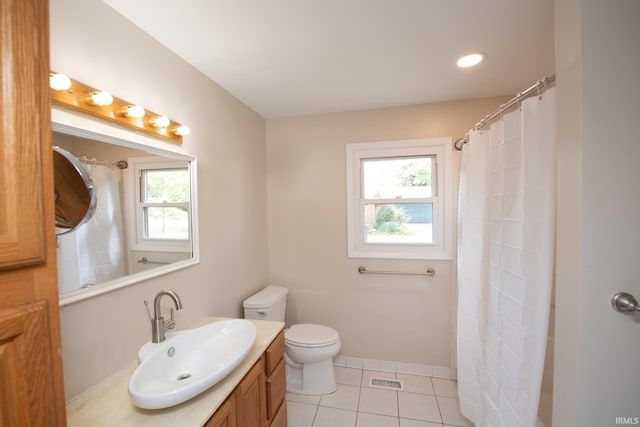 bathroom featuring vanity, tile patterned floors, and toilet