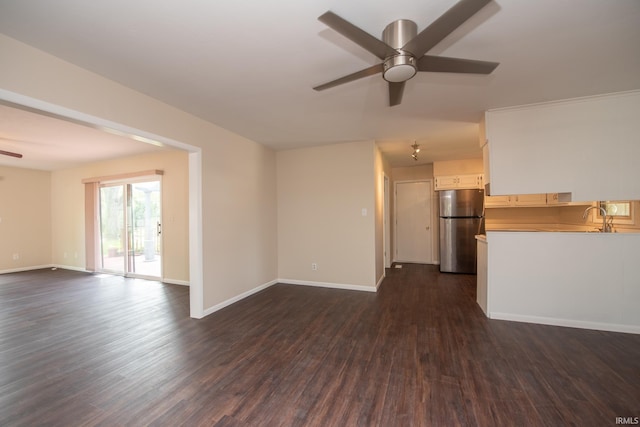 unfurnished living room featuring dark hardwood / wood-style flooring, sink, and ceiling fan