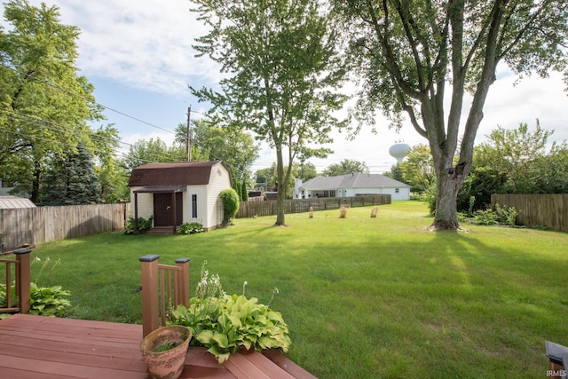 view of yard with a wooden deck and a shed