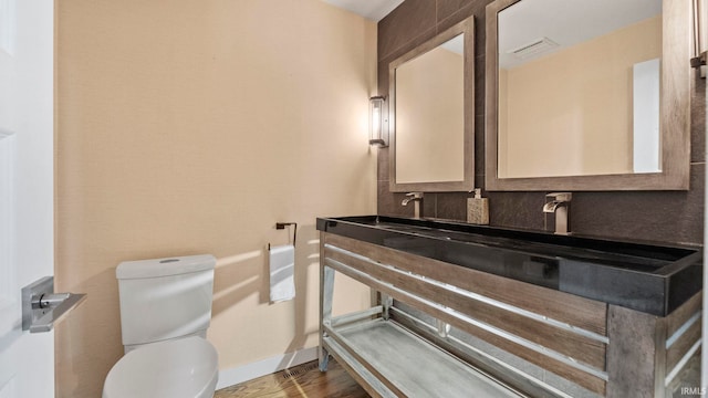 bathroom with vanity, hardwood / wood-style floors, and toilet