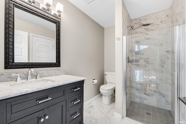 bathroom with vanity, a shower with shower door, and toilet