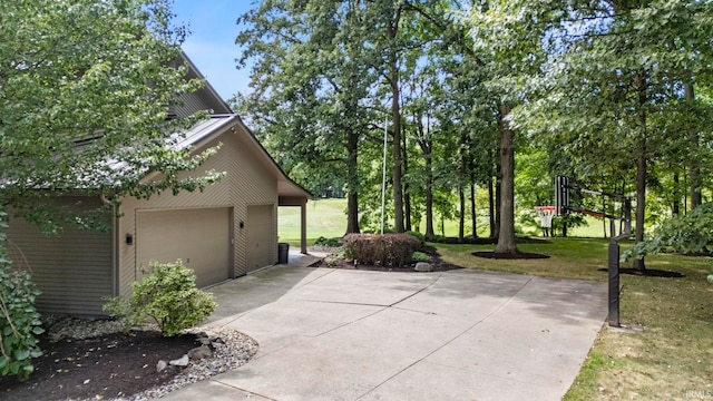 view of side of home with a garage and a yard