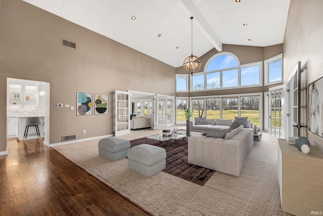 living room with high vaulted ceiling, a notable chandelier, wood-type flooring, french doors, and beamed ceiling