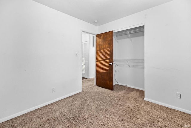 unfurnished bedroom featuring carpet floors and a closet