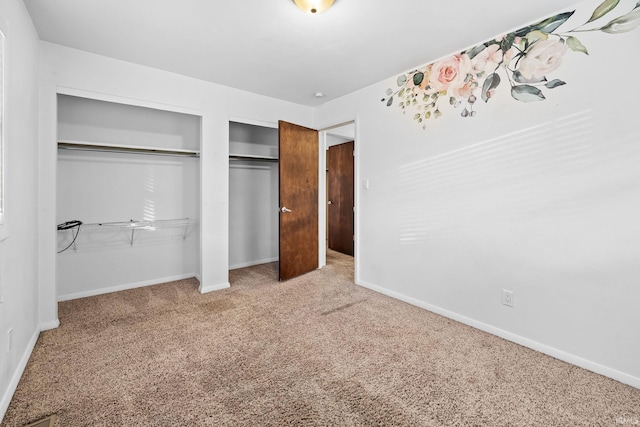 unfurnished bedroom featuring a closet and carpet flooring