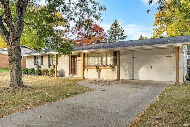 ranch-style home featuring a garage and a front lawn