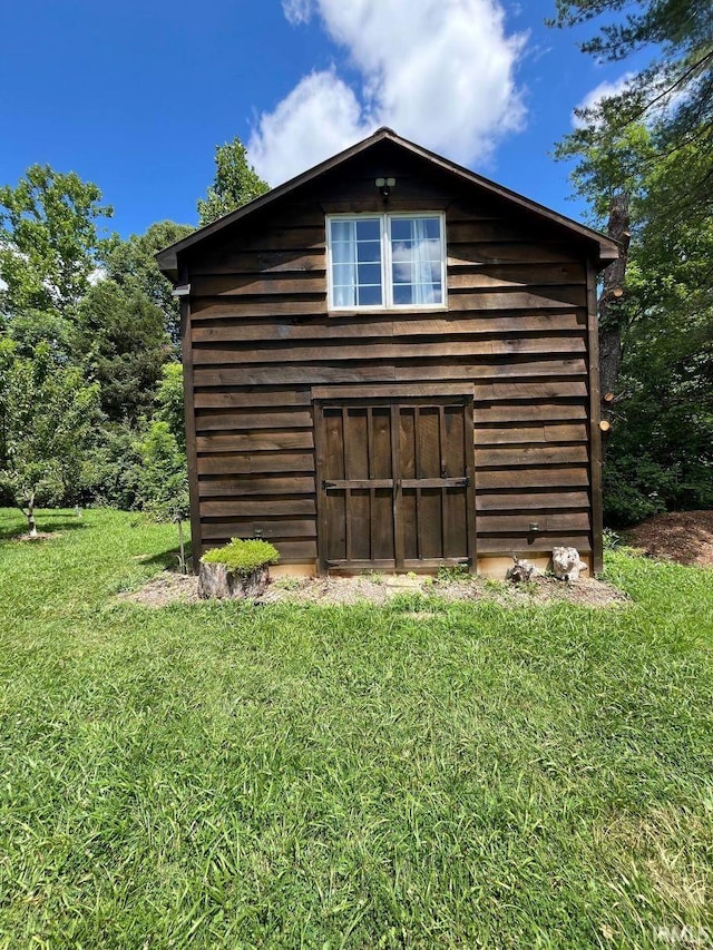 view of outbuilding featuring a yard