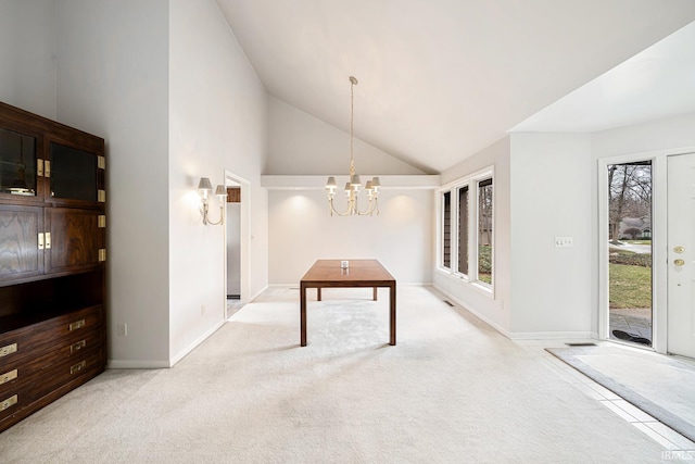 unfurnished dining area featuring a notable chandelier, light colored carpet, and high vaulted ceiling