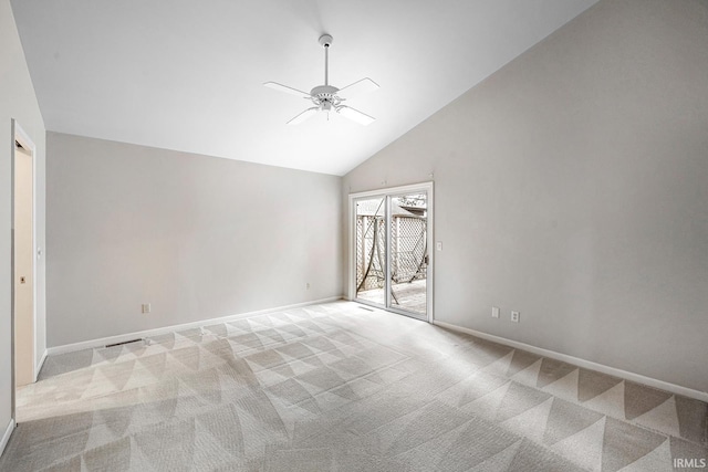 carpeted spare room featuring high vaulted ceiling and ceiling fan