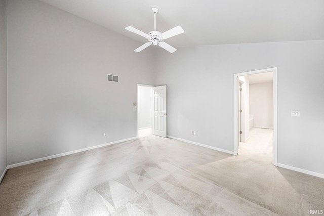 spare room with light carpet, high vaulted ceiling, and ceiling fan