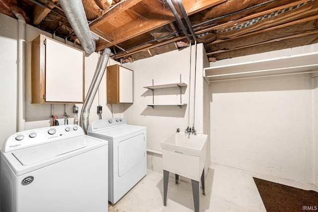 laundry area with washer and dryer and cabinets