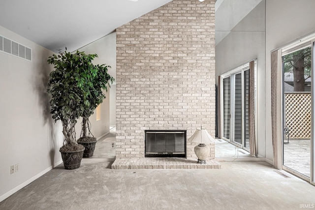 unfurnished living room with high vaulted ceiling, carpet floors, and a brick fireplace