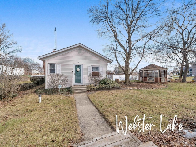 view of front of home featuring a gazebo and a front yard