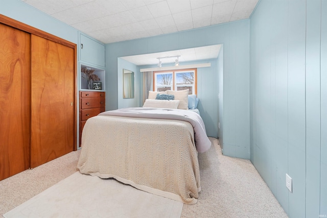 carpeted bedroom featuring a closet