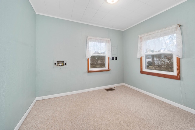 carpeted spare room with crown molding