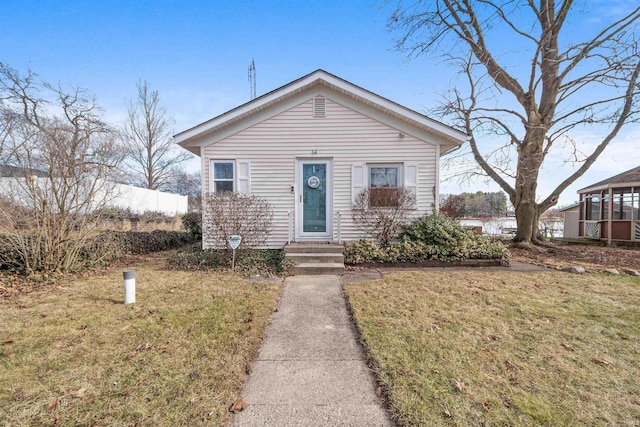 bungalow-style home with a front lawn