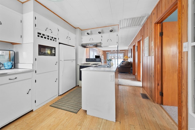 kitchen featuring sink, white appliances, light hardwood / wood-style floors, and white cabinets