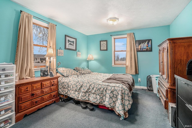 carpeted bedroom with multiple windows and a textured ceiling