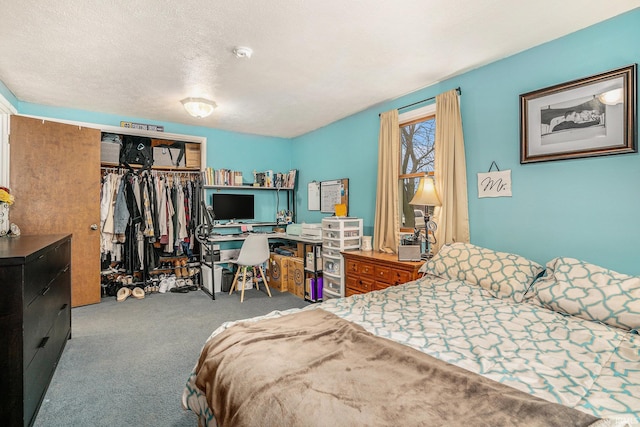 bedroom with light colored carpet, a closet, and a textured ceiling