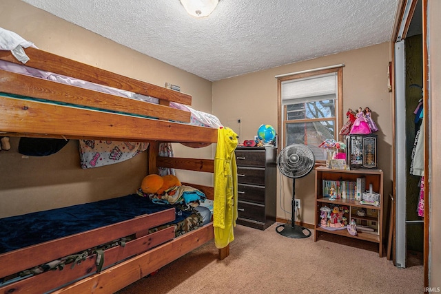 bedroom with light carpet and a textured ceiling