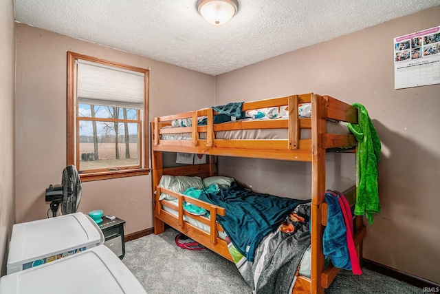 carpeted bedroom with a textured ceiling