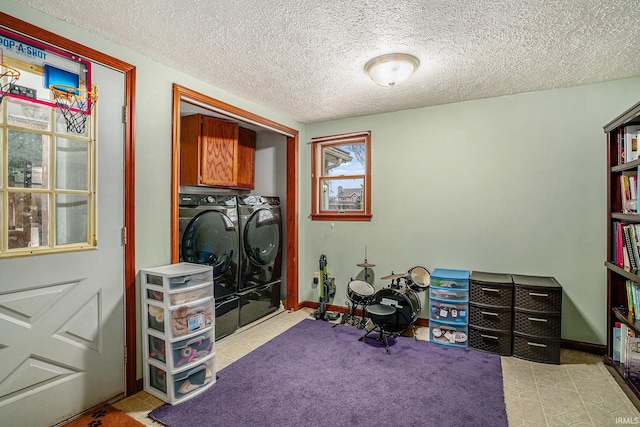 interior space featuring separate washer and dryer and a textured ceiling