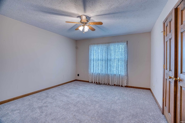 spare room with light carpet, a textured ceiling, and ceiling fan