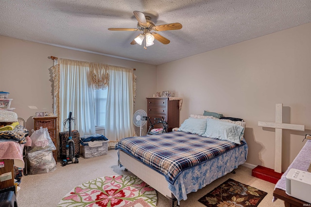 carpeted bedroom with ceiling fan and a textured ceiling