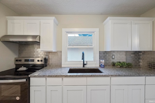 kitchen featuring white cabinetry, sink, stainless steel electric range, and light stone counters