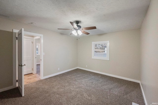 unfurnished bedroom featuring ceiling fan, carpet flooring, and a textured ceiling