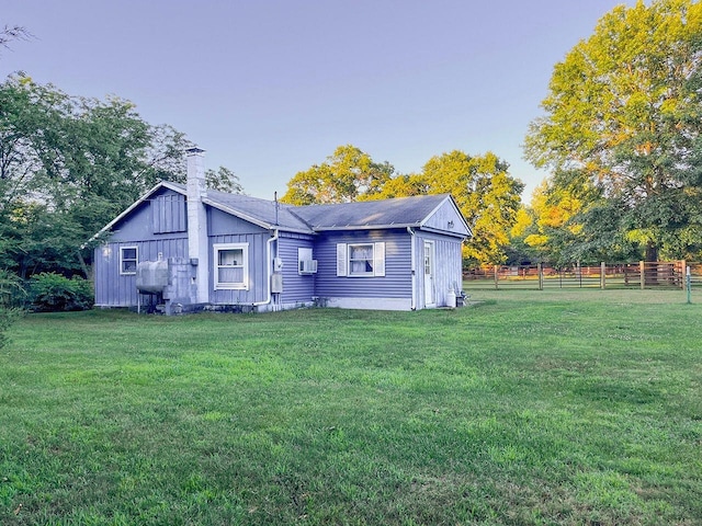 back of property with a lawn