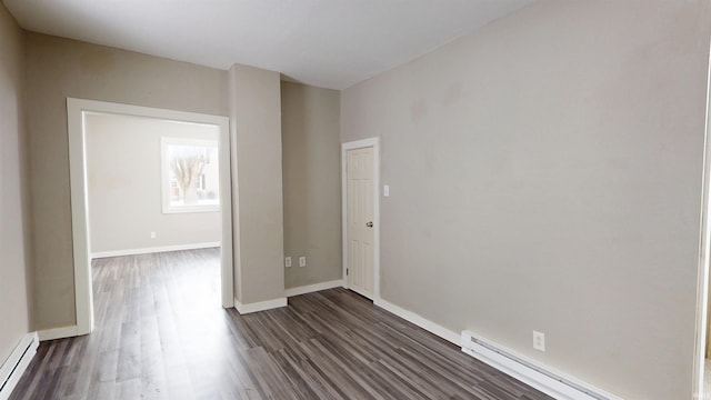 unfurnished room with baseboard heating, baseboards, a baseboard radiator, and dark wood-type flooring