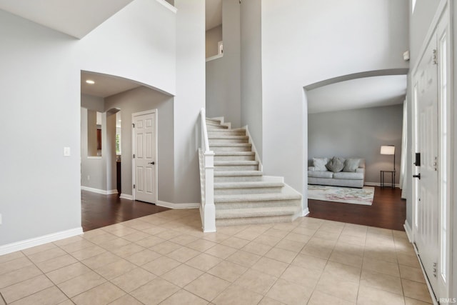 tiled foyer with a high ceiling