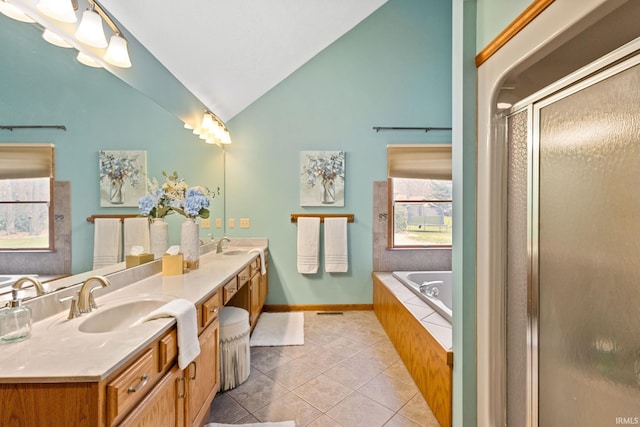 bathroom with tile patterned floors, independent shower and bath, vaulted ceiling, and vanity