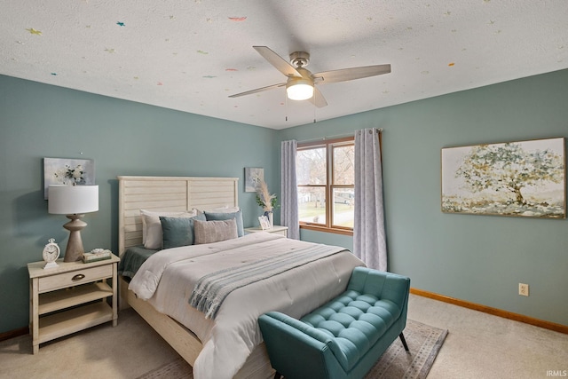 bedroom featuring ceiling fan, carpet floors, and a textured ceiling