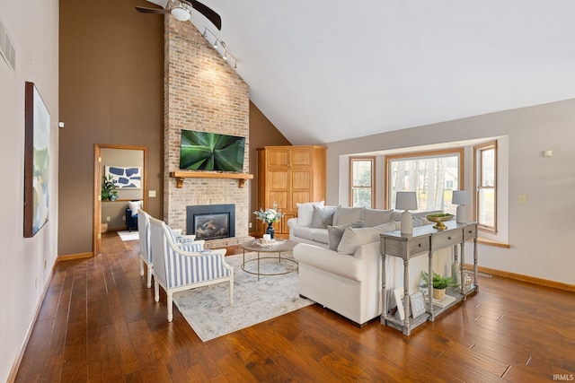 living room with a fireplace, high vaulted ceiling, dark hardwood / wood-style floors, and ceiling fan