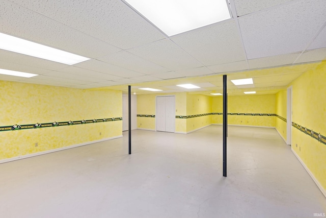 basement with a paneled ceiling