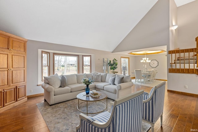 living room with an inviting chandelier, dark wood-type flooring, and high vaulted ceiling