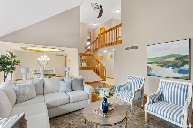 living room with a high ceiling and an inviting chandelier