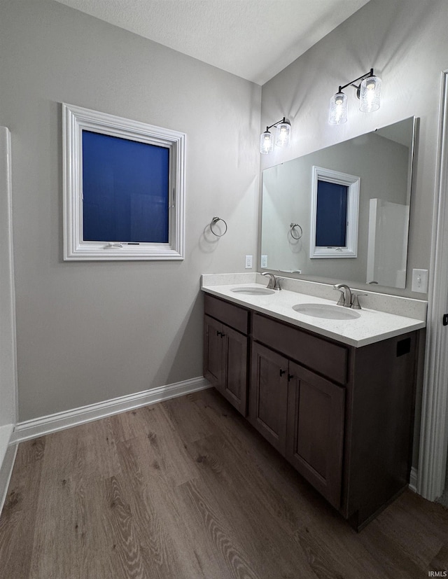 bathroom featuring vanity, hardwood / wood-style floors, and a textured ceiling