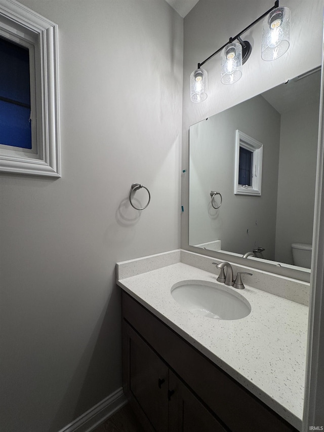 bathroom featuring vanity and toilet