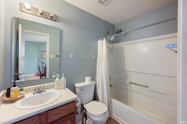 full bathroom featuring vanity, toilet, a textured ceiling, and shower / bath combo