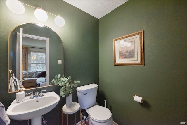 bathroom featuring sink and toilet