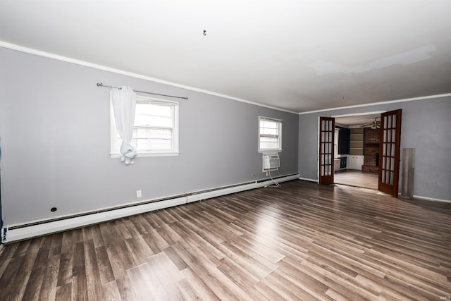 empty room featuring a wealth of natural light, ornamental molding, french doors, and baseboard heating