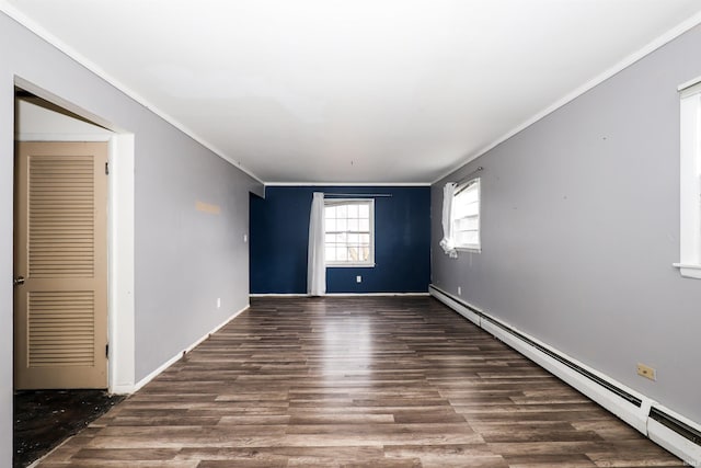 unfurnished room featuring crown molding, dark wood-type flooring, and a baseboard heating unit