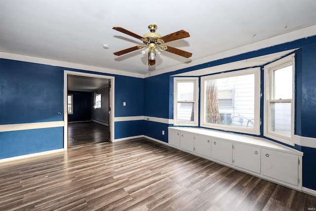 spare room with hardwood / wood-style flooring and ceiling fan