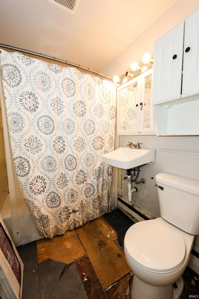 bathroom featuring walk in shower, sink, hardwood / wood-style floors, and toilet