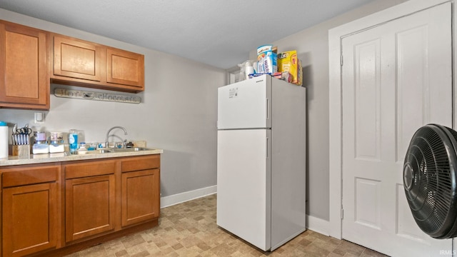 kitchen with white refrigerator and sink